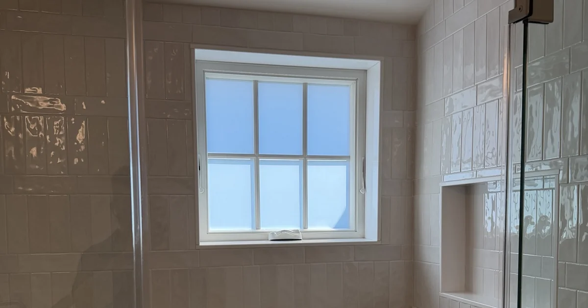 Frosted bathroom window set into a tiled shower wall